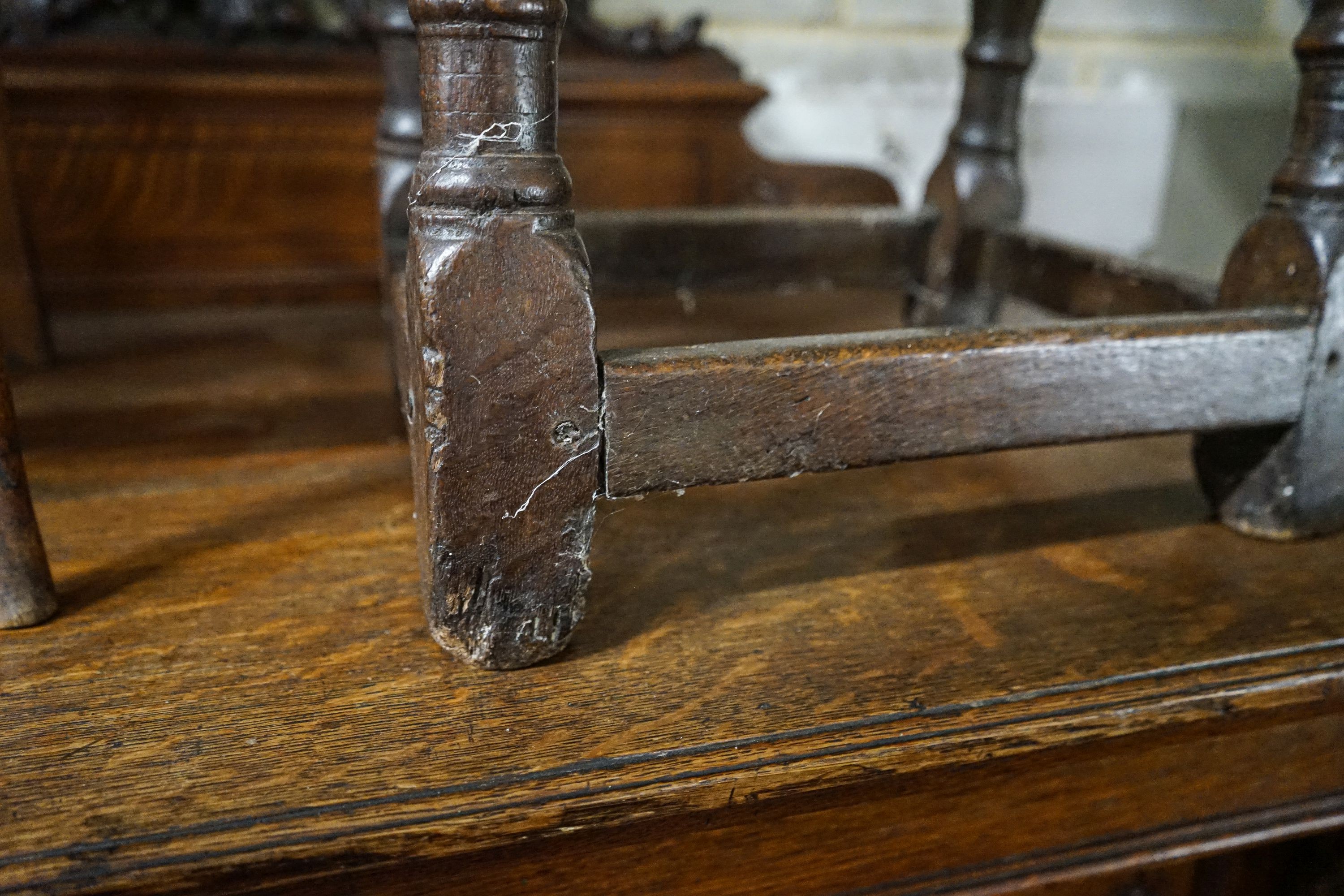 A 17th century style oak joint stool, with foliate carved frieze and turned legs, width 44cm, depth 28cm, height 56cm